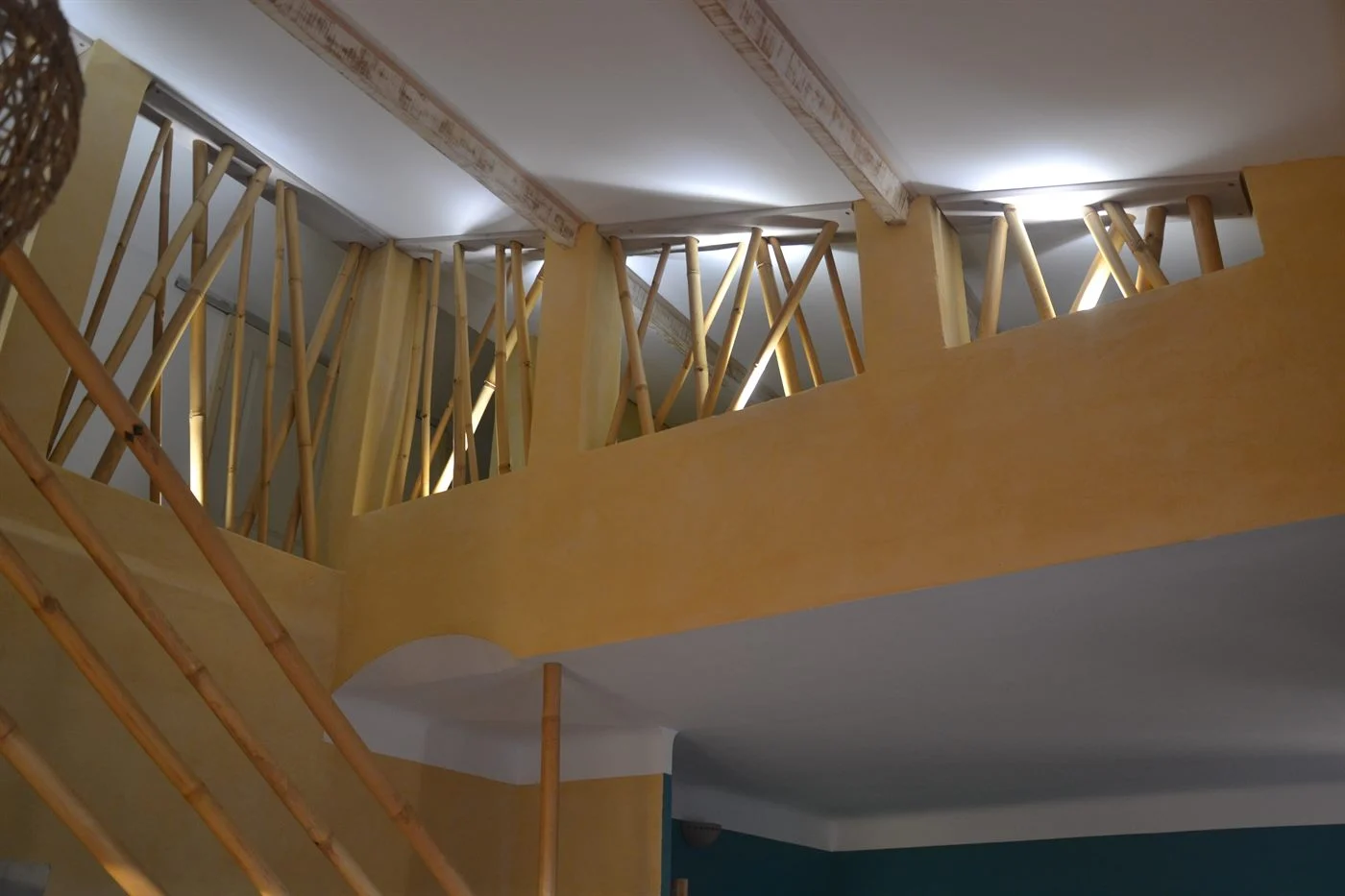 Garde-corps de mezzanine en bambous obliques, vu depuis l'escalier